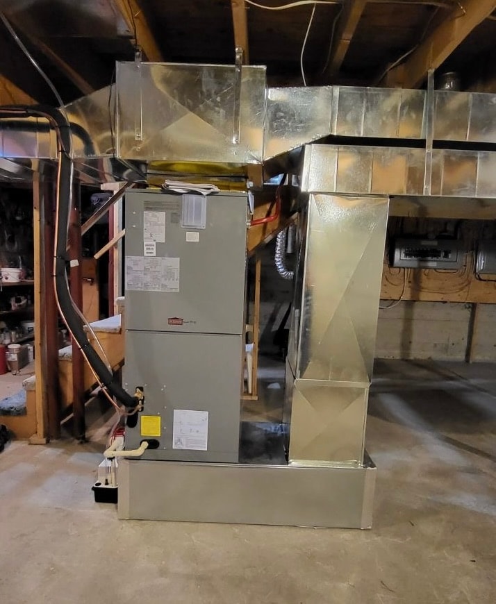 Central heat pump air handler with custom ductwork installed in residential basement