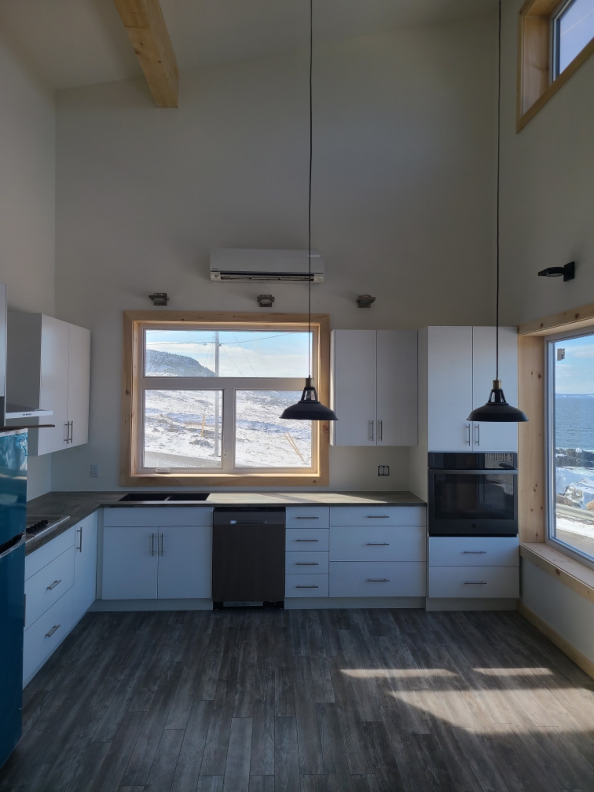 Mini split indoor wall unit installed in modern kitchen with ocean view