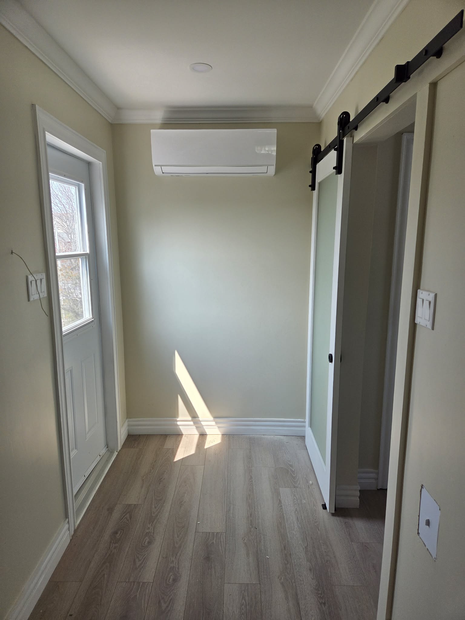 Mini split indoor head unit in bright hallway — clean new install